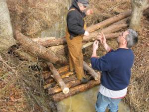 Park Authority staff members Jim Dewing and Dave Lawlor lash logs together.