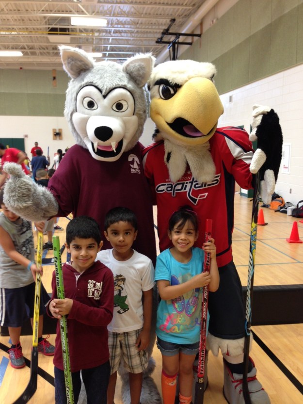 Buddy the Wolf enjoys playing street hockey with Washington Capitals' mascot Slapshot. 