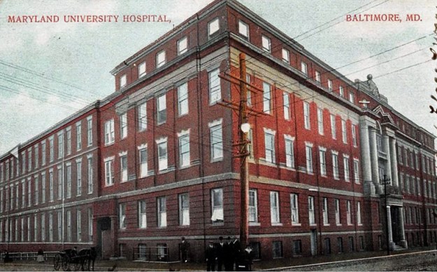A postcard photo of the Maryland University Hospital, where Elizabeth Collins Lee received her nursing training. It is postmarked from Baltimore, MD on Oct. 6, 1909. The postcard shows details such as utility lines, the tracks on the street, and people in period clothing. 