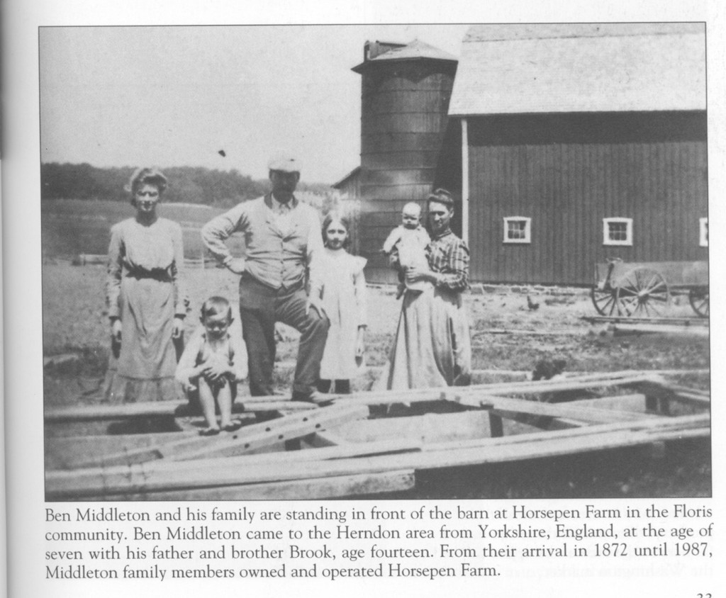 a newspaper clipping of Ben Middleton and his family with text below that reads: Ben Middleton and his family are standing in front of the barn at Horsepen Farm in the Floris community. Ben Middleton came to the Herndon area from Yorkshire, England, at the age of seven with his father and brother Brook, age fourteen. From their arrival in 1872 until 1987, Middleton family members owned and operated Horsepen Farm.