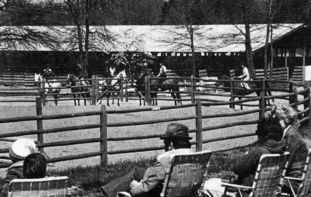 an old black and white photo of people watching a horse show